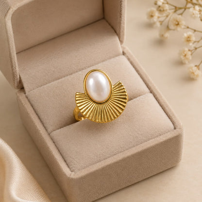 Gold-tone pearl statement ring with fan-shaped detailing displayed in a beige jewellery box