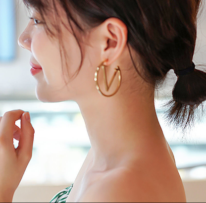 Gold “V” Logo Hoop Earrings – Modern Iconic Statement